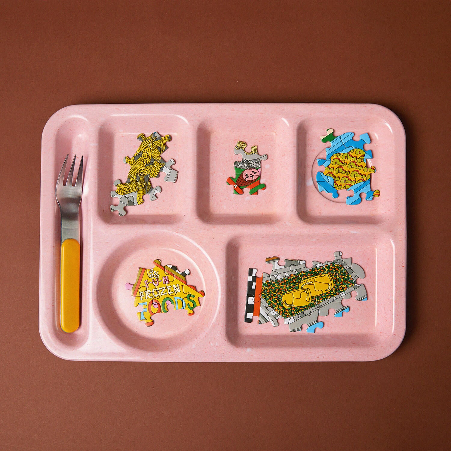 Pink children's tray with colorful illustrations on a brown background