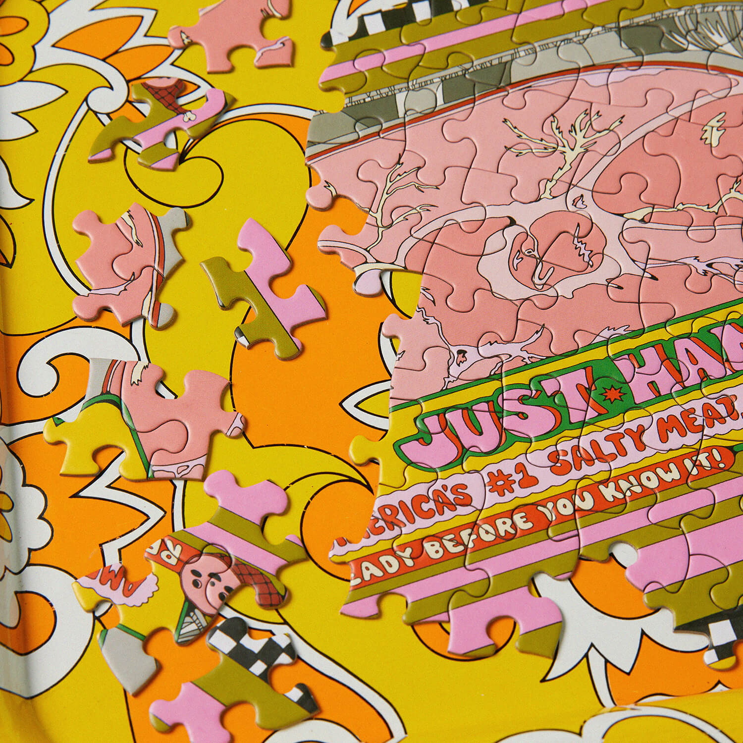 Partial puzzle with colorful pieces on a yellow background