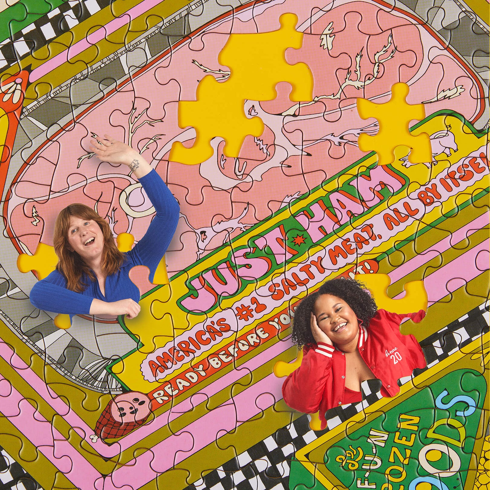 Two people posing with a colorful puzzle featuring a 'Just a Ham' advertisement.