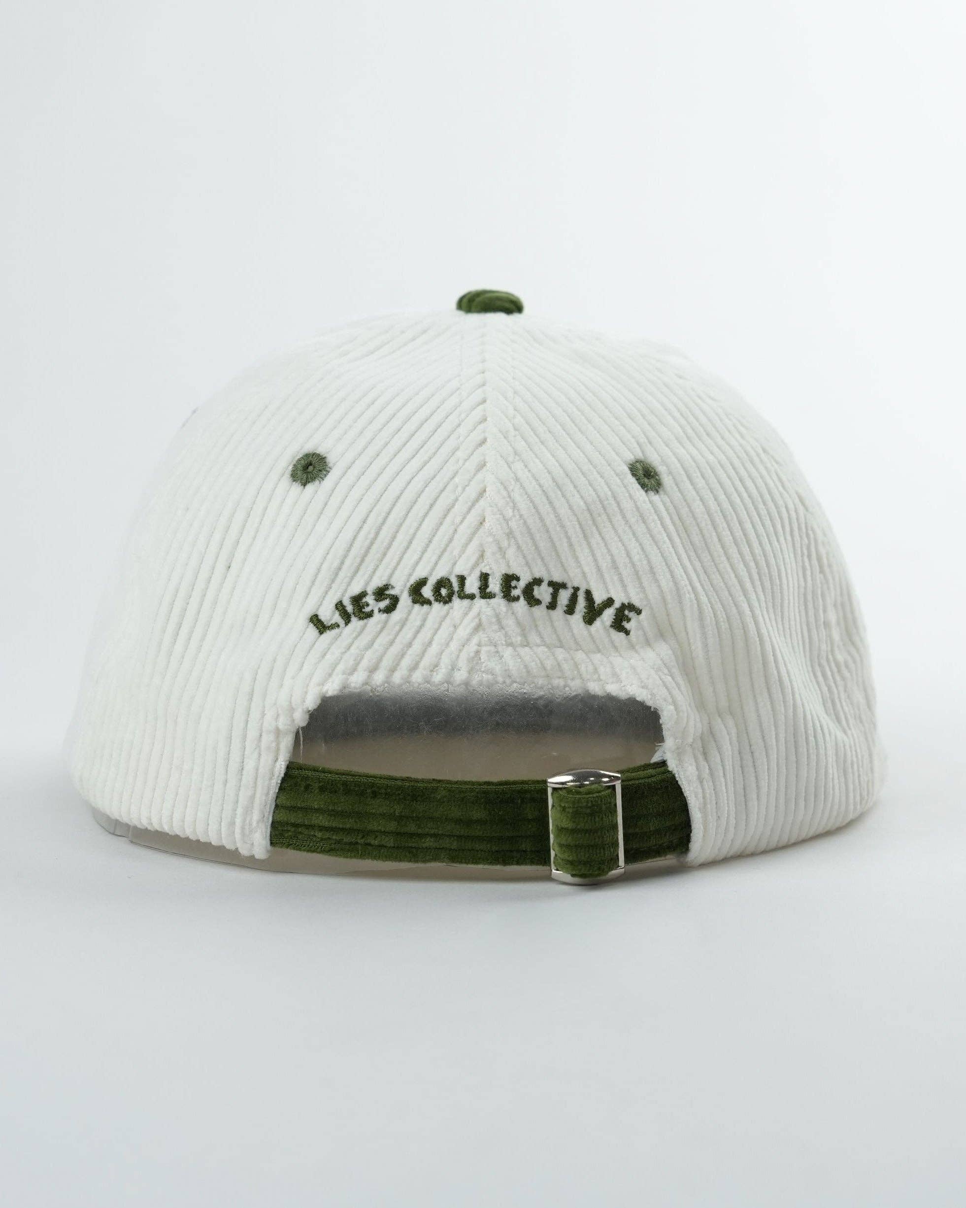 White cap with green accents and 'LIES COLLECTIVE' branding on a light gray background