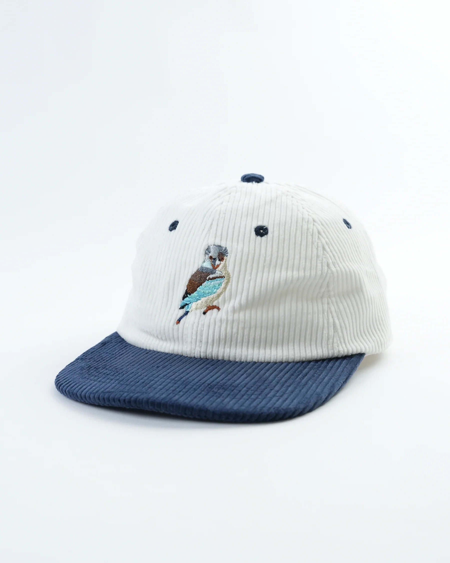 White and blue cap with a bird design on a white background