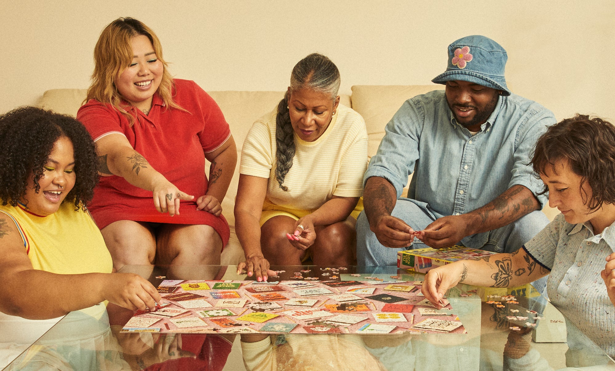 Group of friends assembling the Le Puzz Match Made in Heaven 1000-piece jigsaw puzzle together