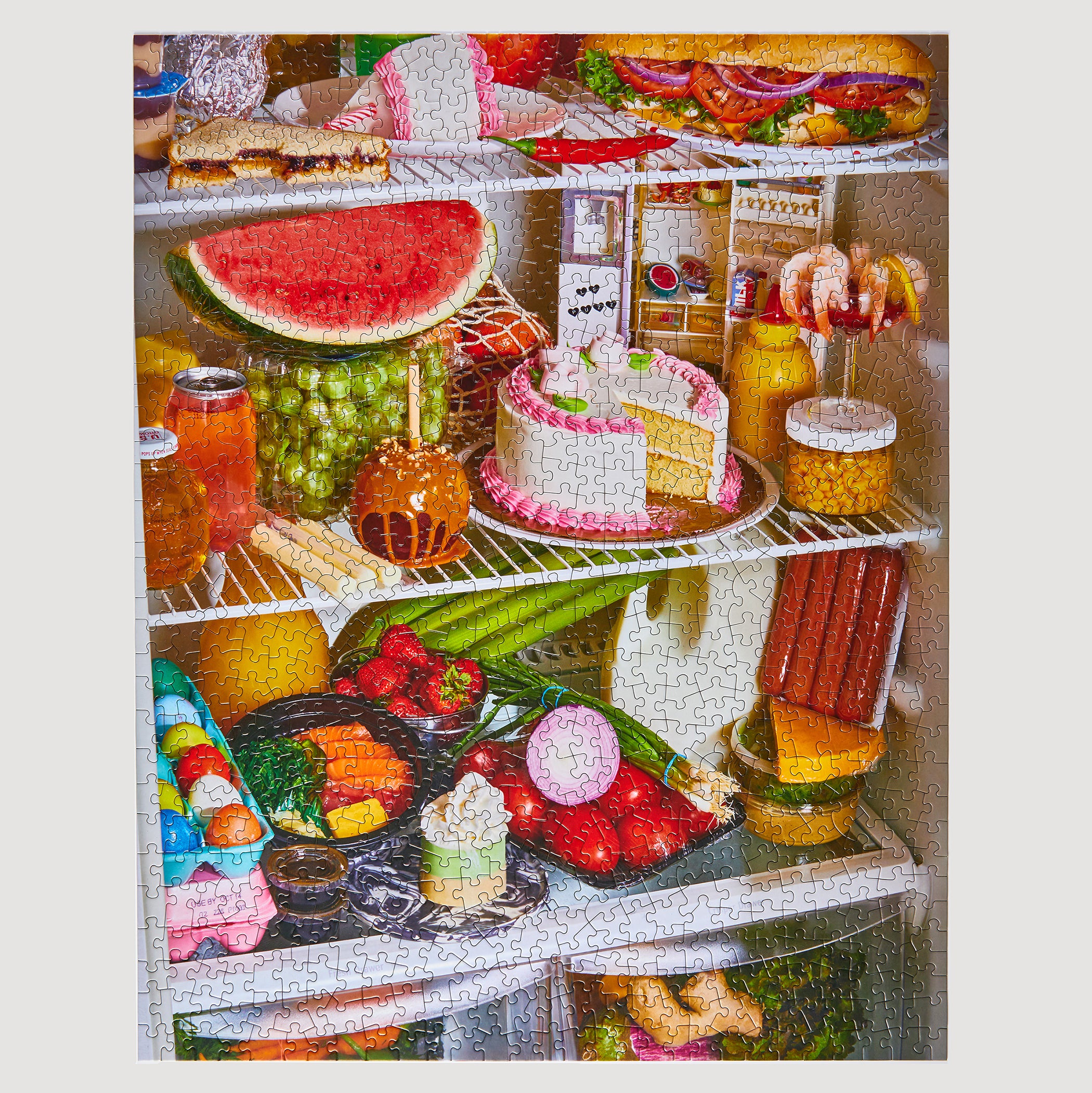Completed Le Puzz Midnight Snack 1000-piece jigsaw puzzle showing a vibrant open fridge packed with colourful food and snacks