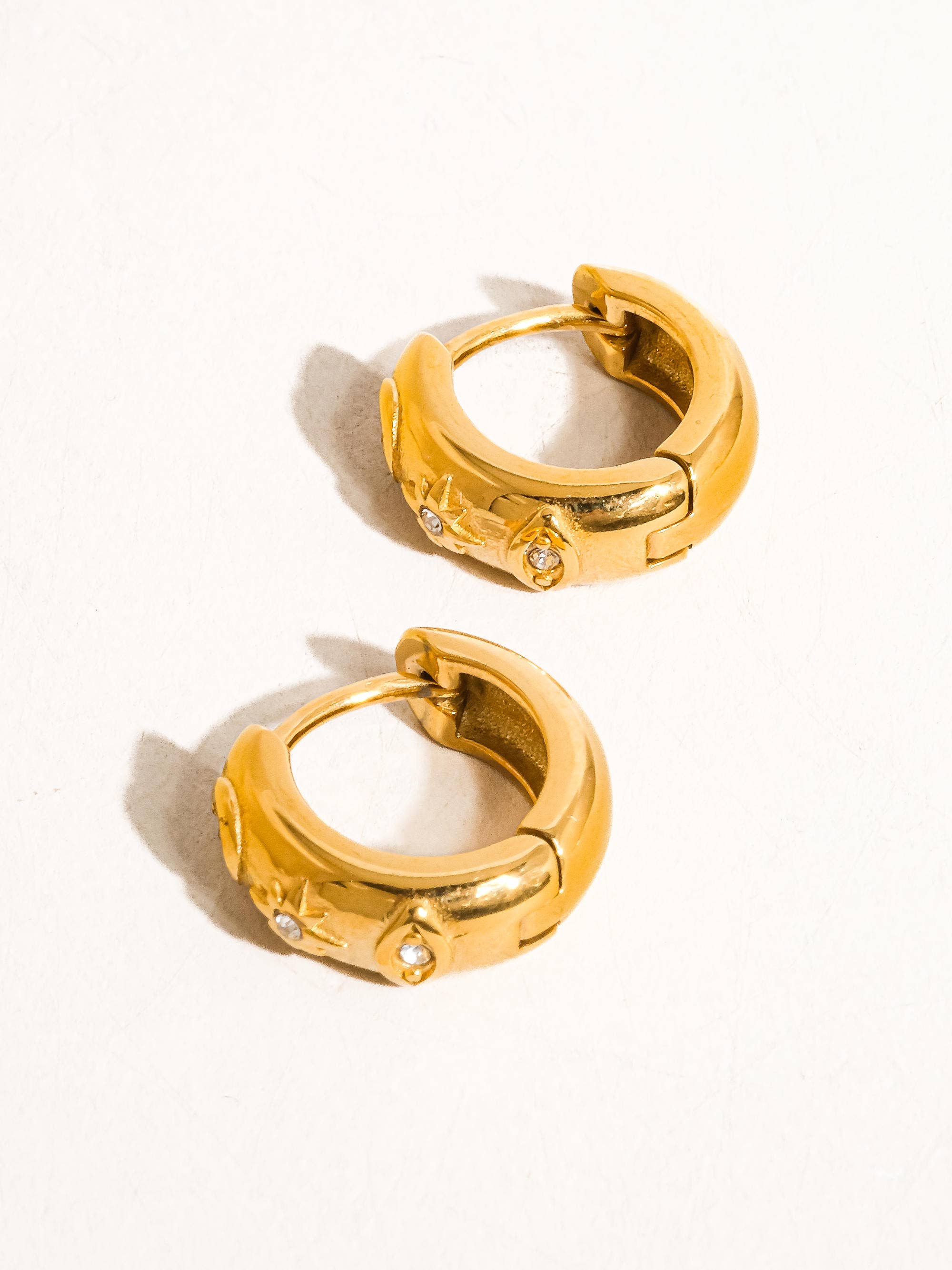Gold hoop earrings on a white background