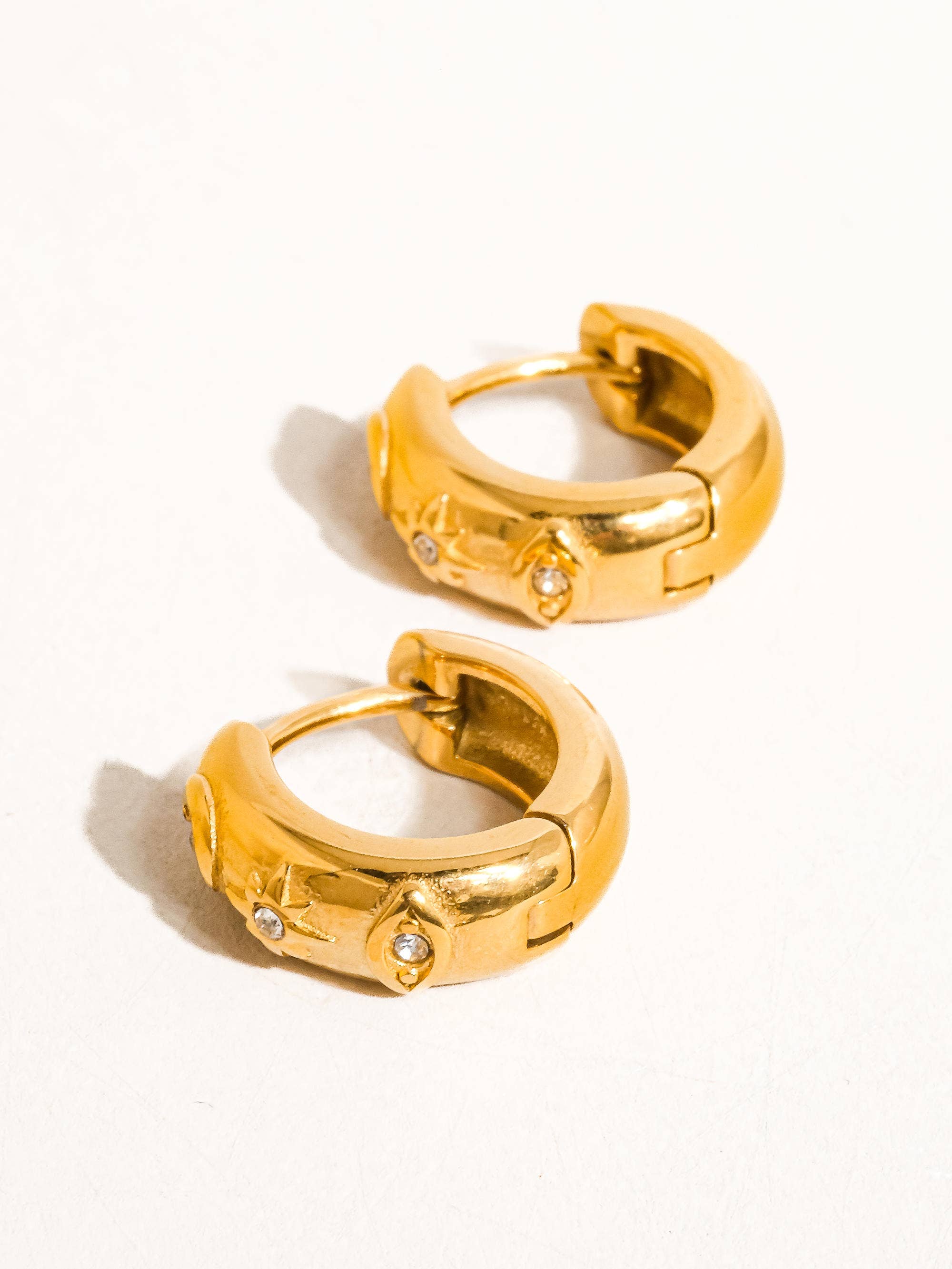 Pair of gold hoop earrings on a white background