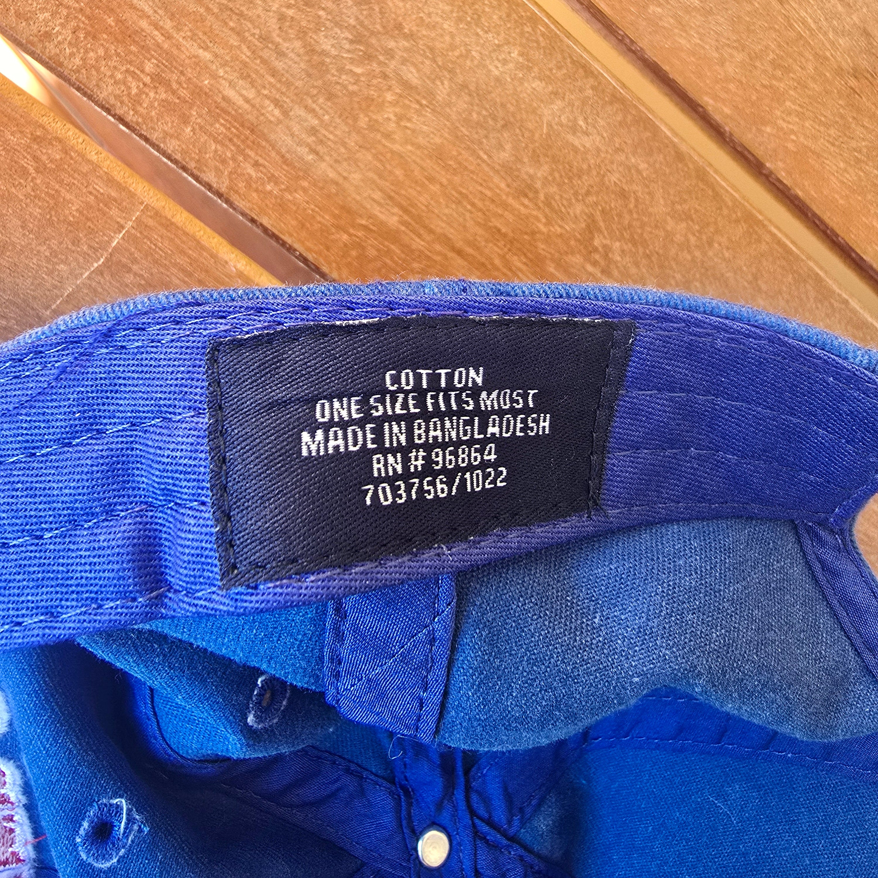 Blue glove with a label on a wooden surface