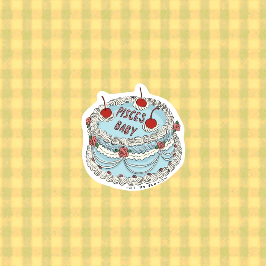 Sticker with cake design and 'Pisces Baby' text on a striped background