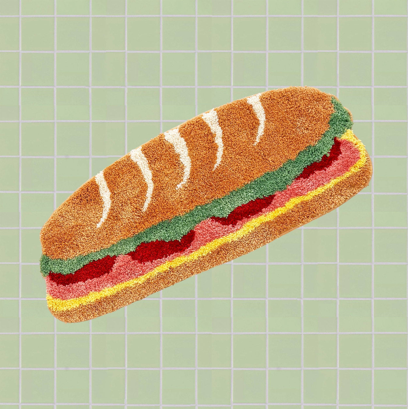 Rug shaped like a sandwich on a green grid background