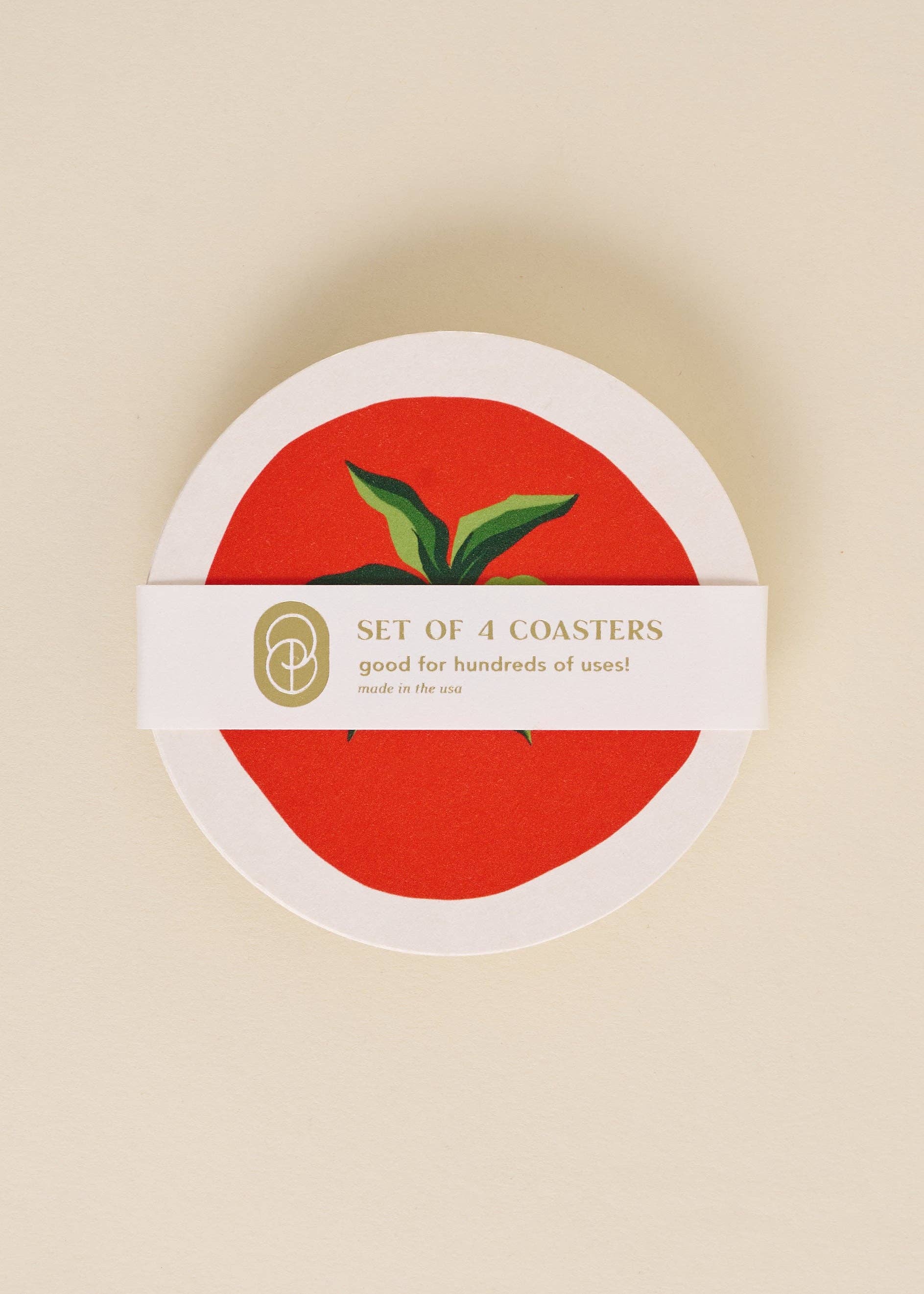 Set of 4 coasters with a red center and green leaves on a beige background