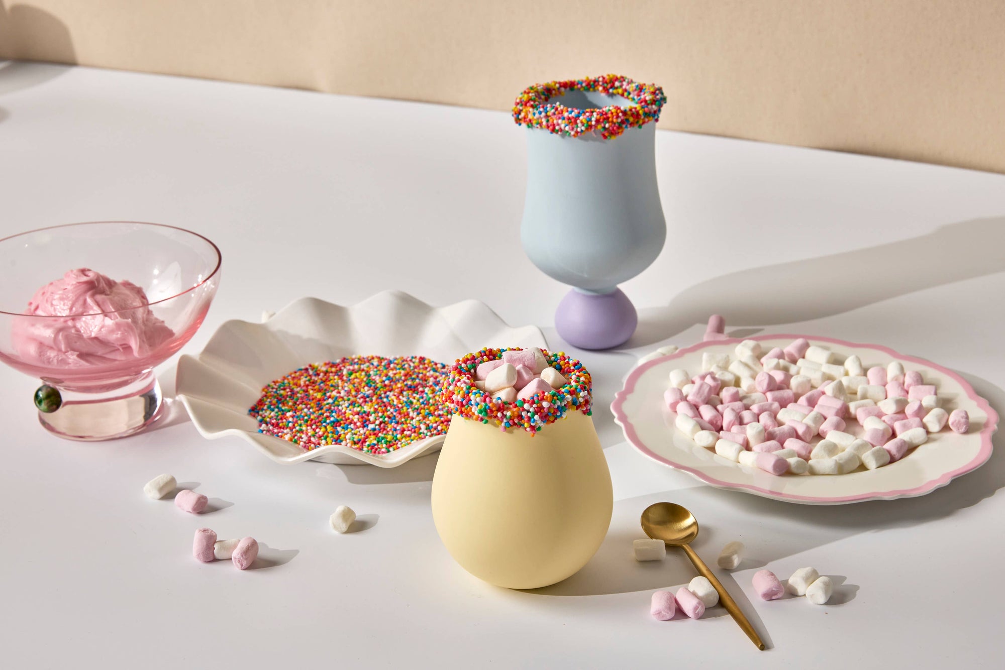Colorful treats on a white surface with a beige background