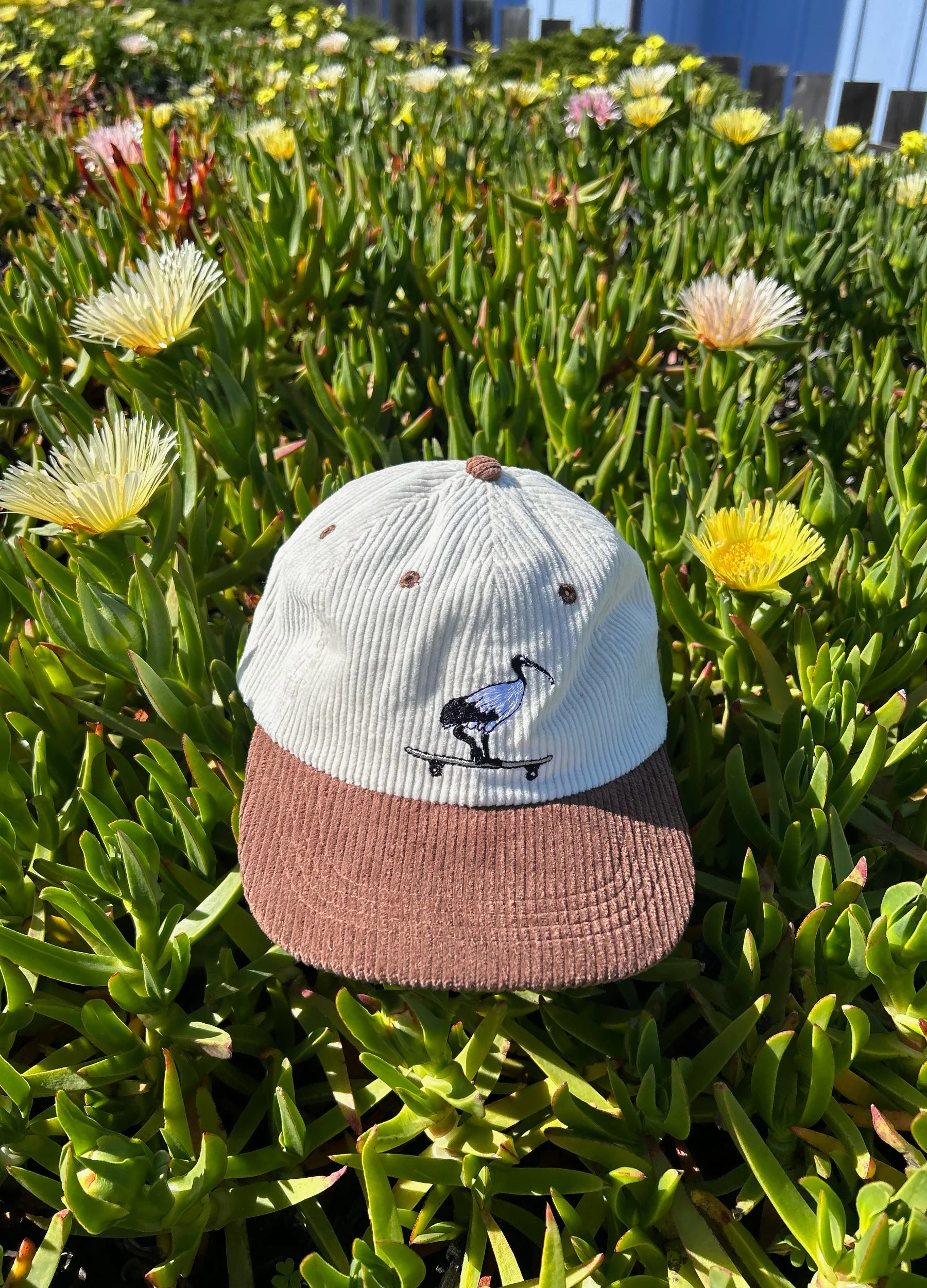 Cap with a design on a background of green foliage and yellow flowers