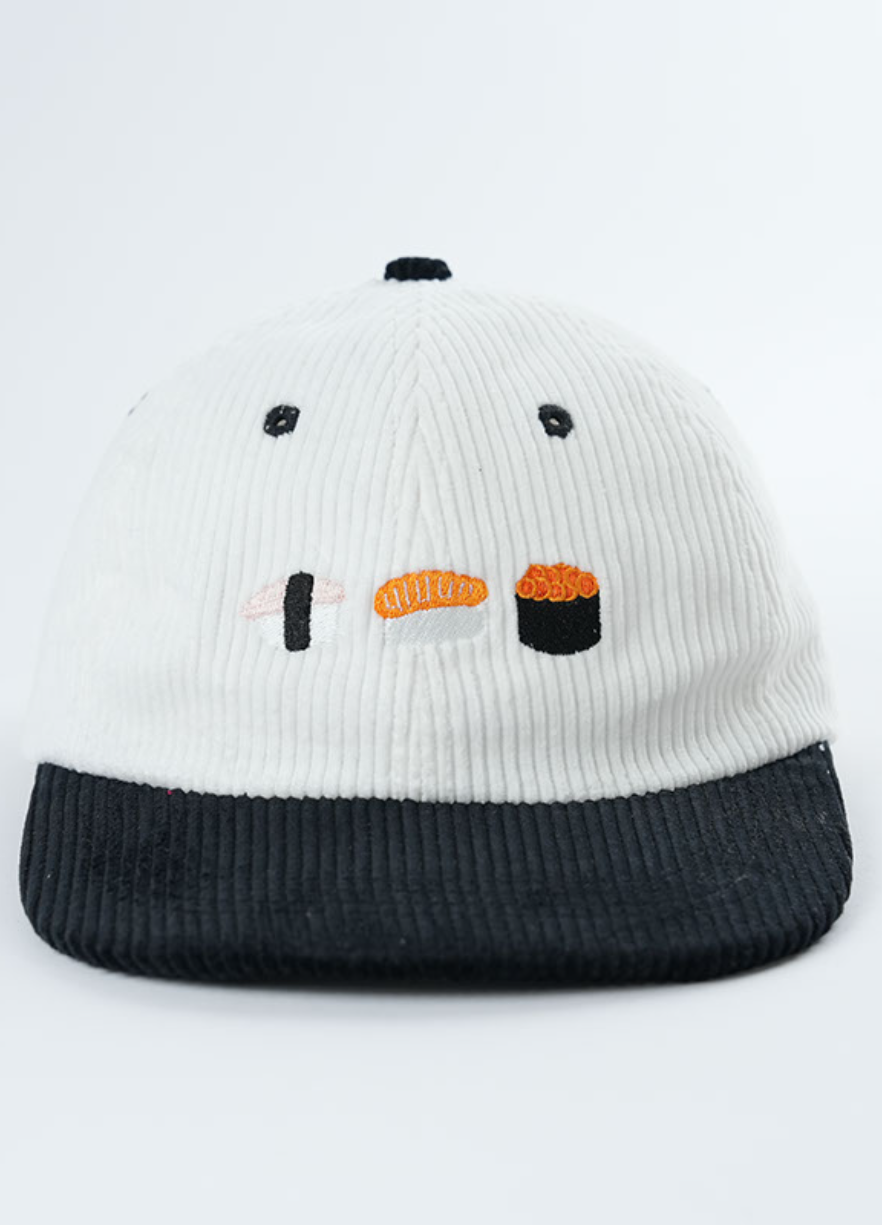 White and black cap with sushi design on a white background