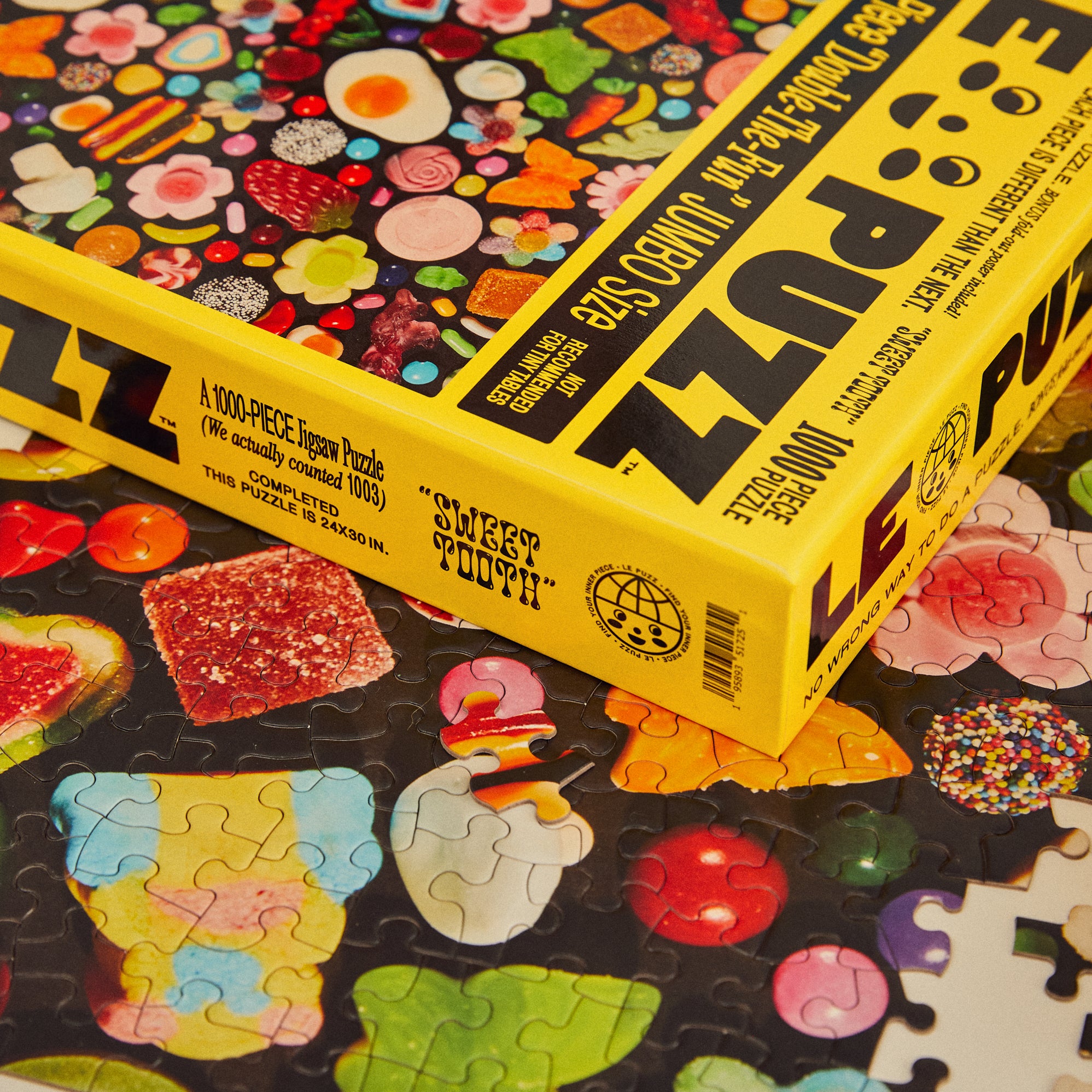 Colorful puzzle with a box labeled 'Sweet Tooth' and 'Puzzle' on a black background.