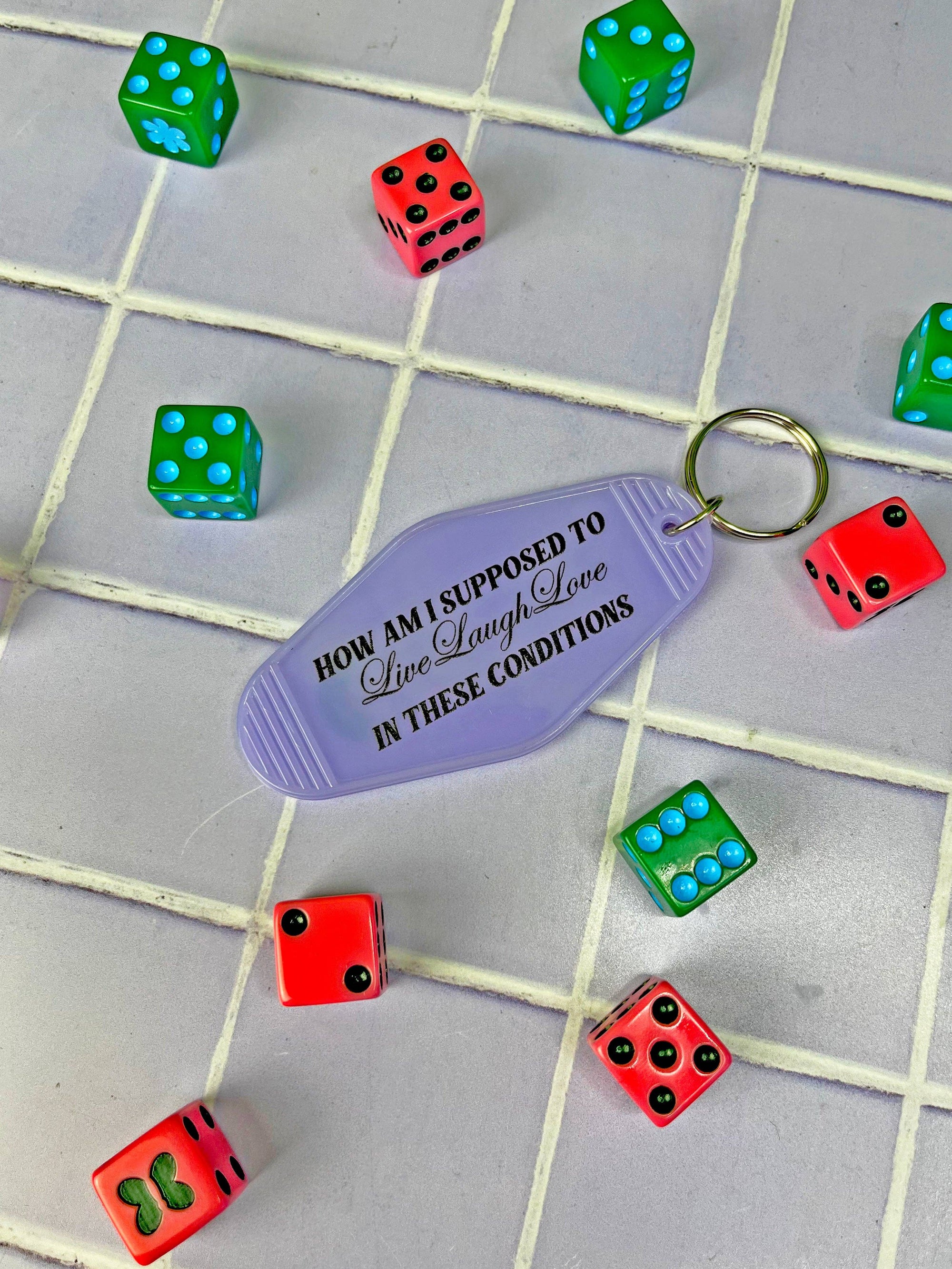 Keychain with humorous text on a checkered background with dice