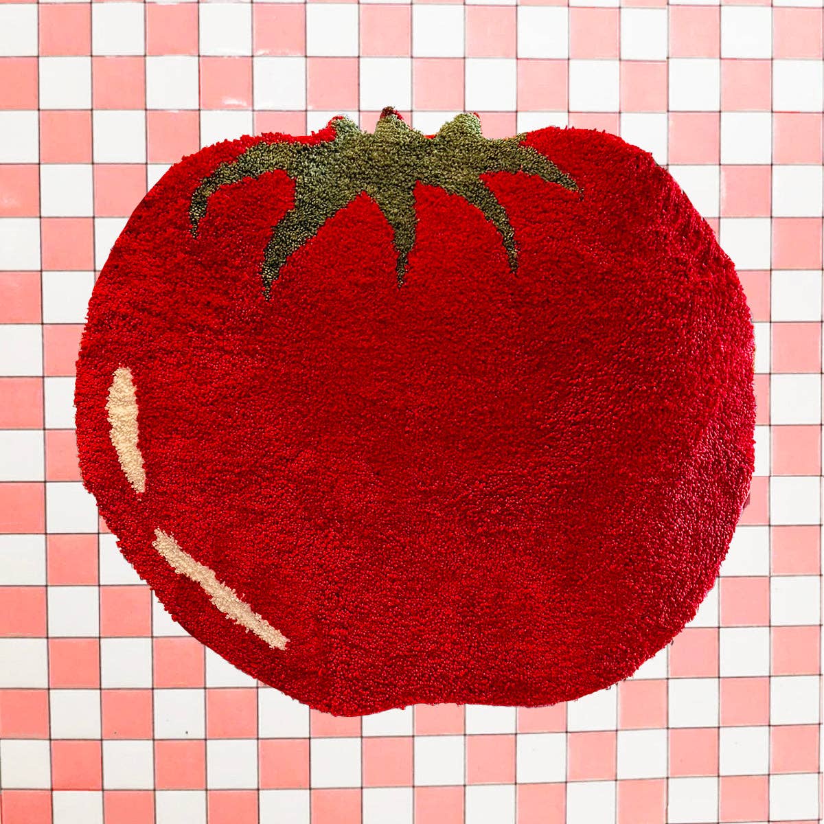 Red tomato-shaped rug on a pink and white checkered background