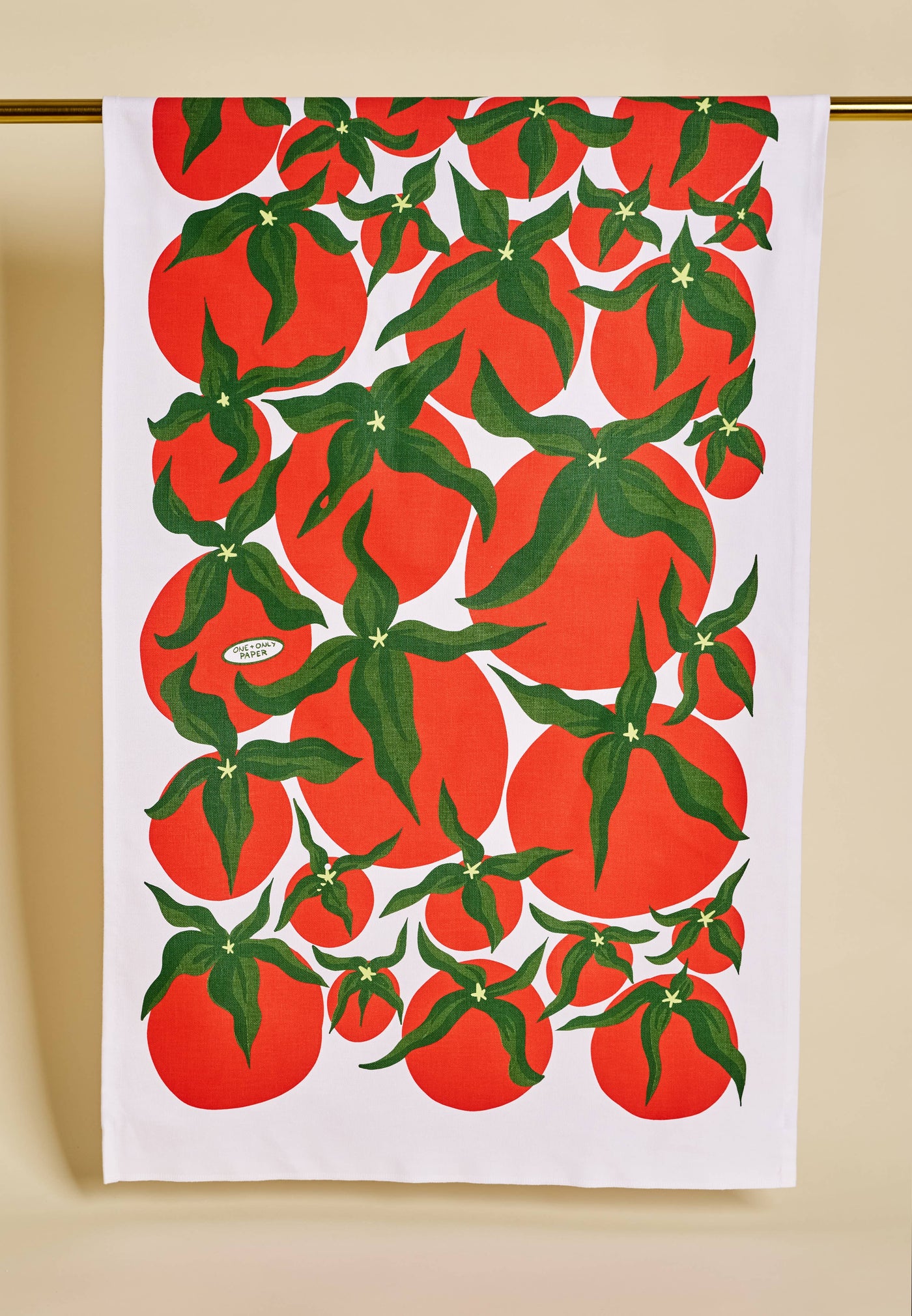 Tea towel with red tomato pattern on a white background