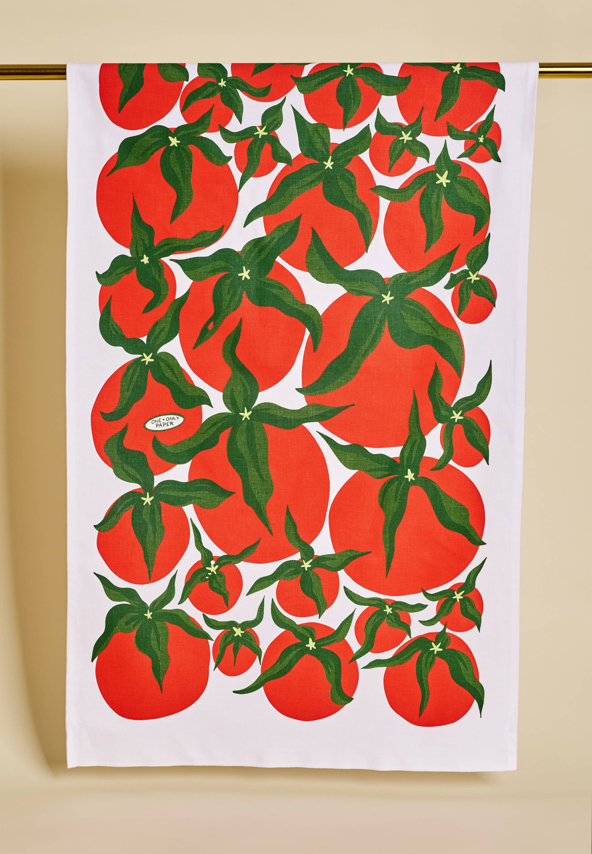 Tea towel with red tomato pattern on a white background