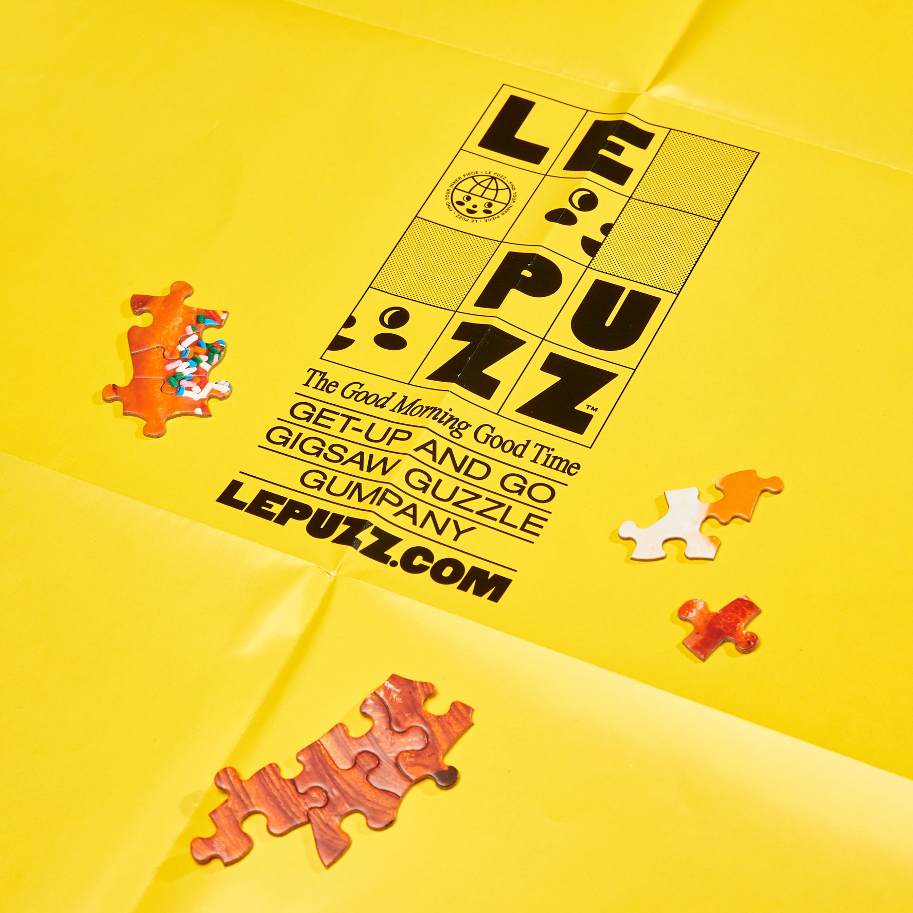 Le Puzz Wakey Wakey yellow resealable bag with scattered breakfast puzzle pieces and Le Puzz branding on a yellow background