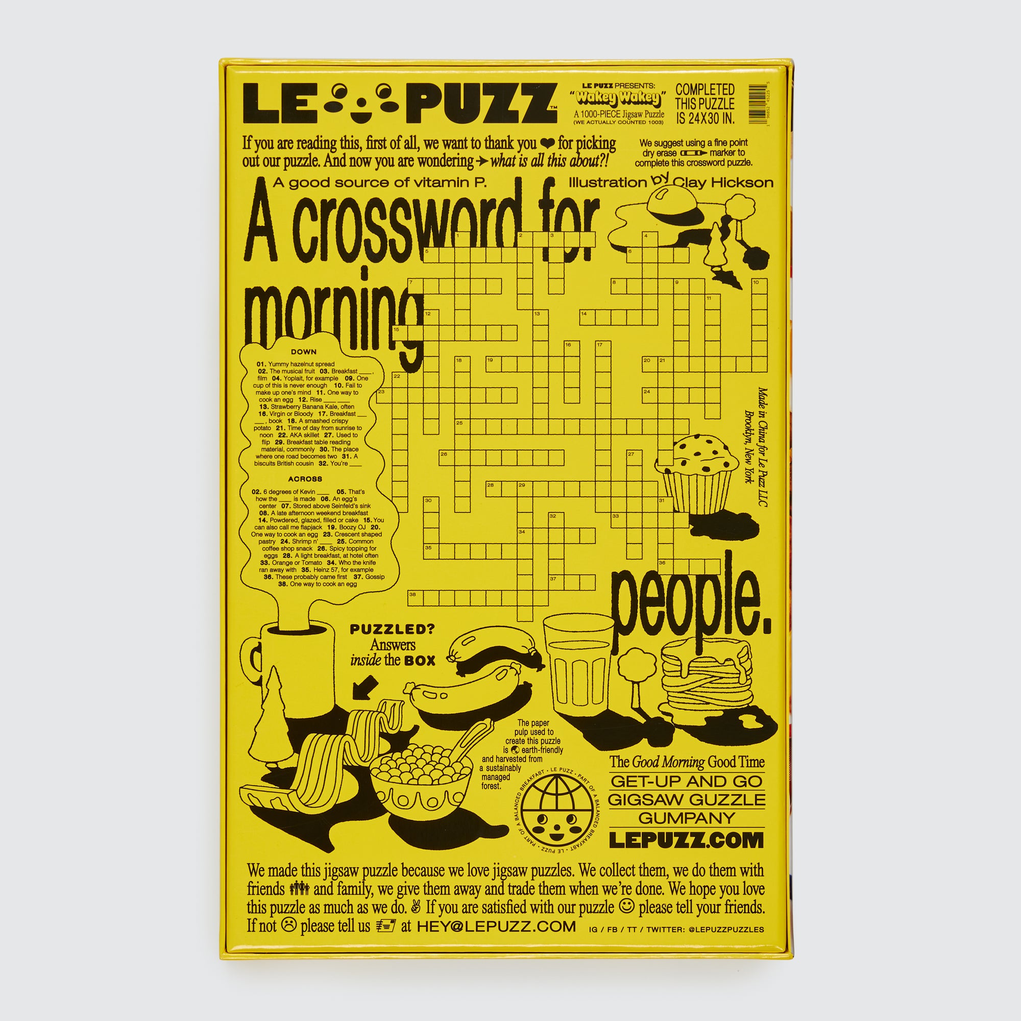 Le Puzz Wakey Wakey puzzle box back featuring a breakfast-themed crossword puzzle illustrated by Clay Hickson on a yellow background